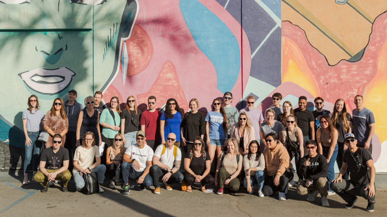 Tiller team in front of a wall mural in Palm Springs